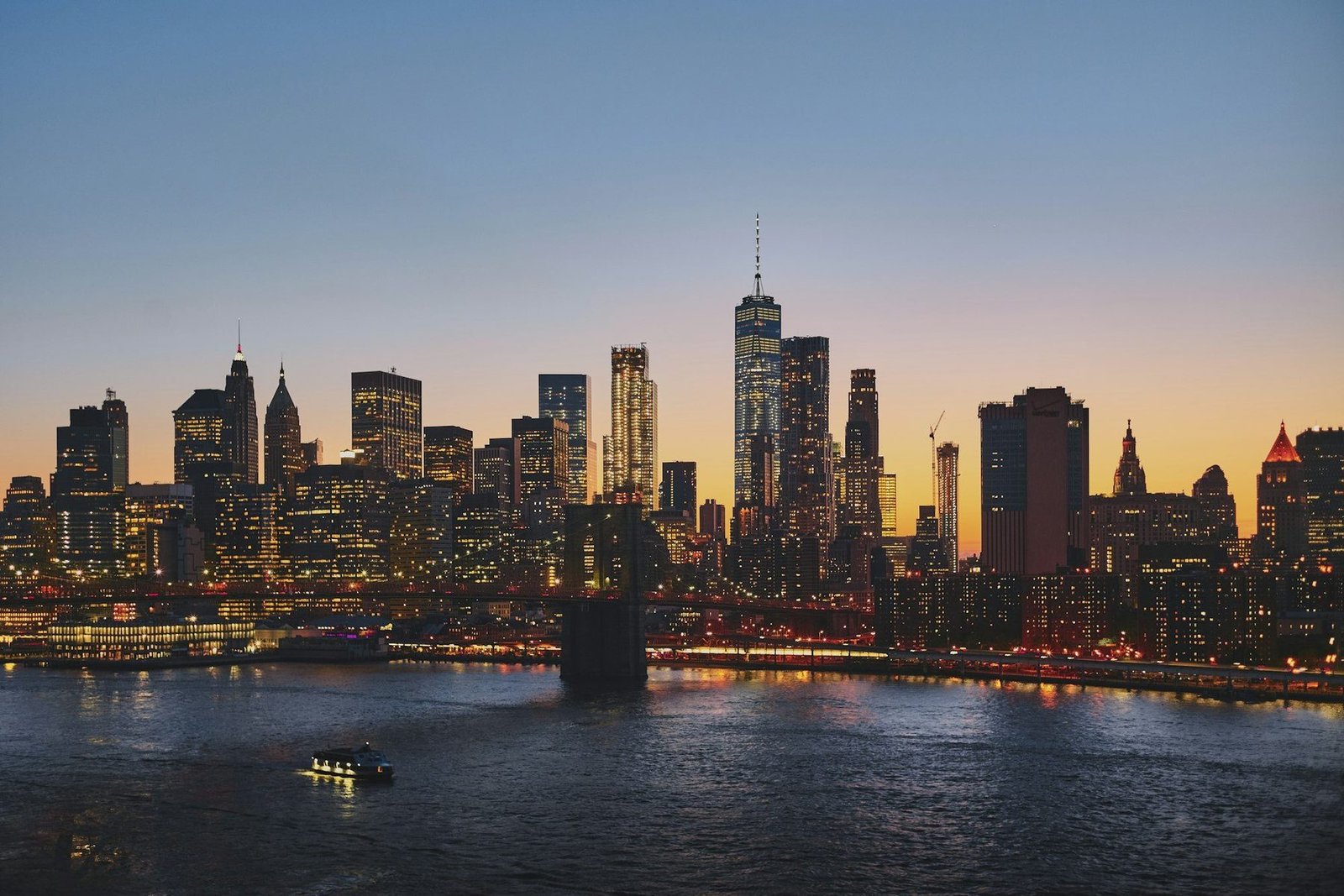 The lower Manhattan skyline at dusk seen across the East River.