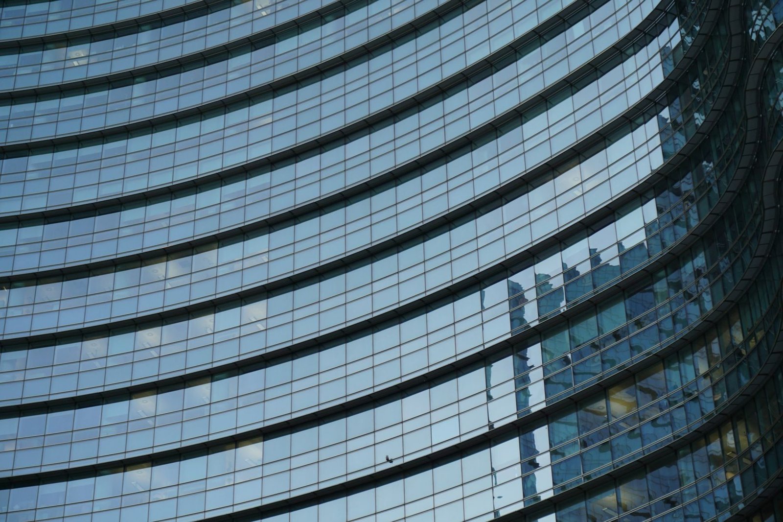The curved glass curtain wall of a Manhattan office tower.